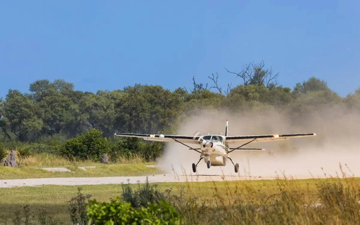 A light aircraft landing at a bush airstrip for an exclusive fly-in variation of the 4 days masai mara and lake nakuru safari.